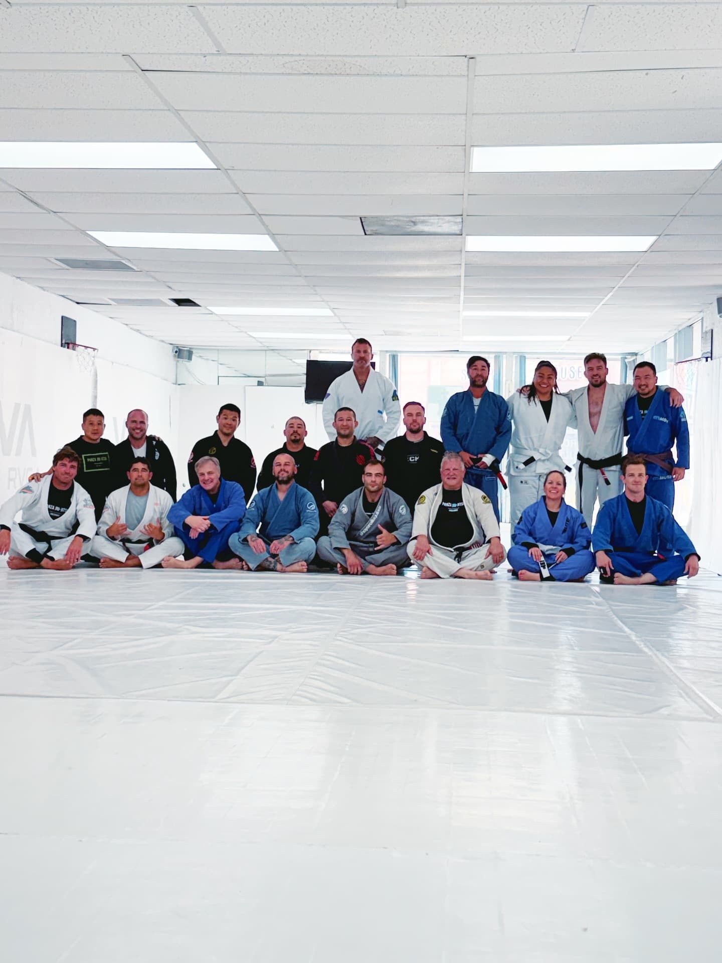 Adults gi class group photo seated on mat at Panza Jiu-Jitsu in Torrance