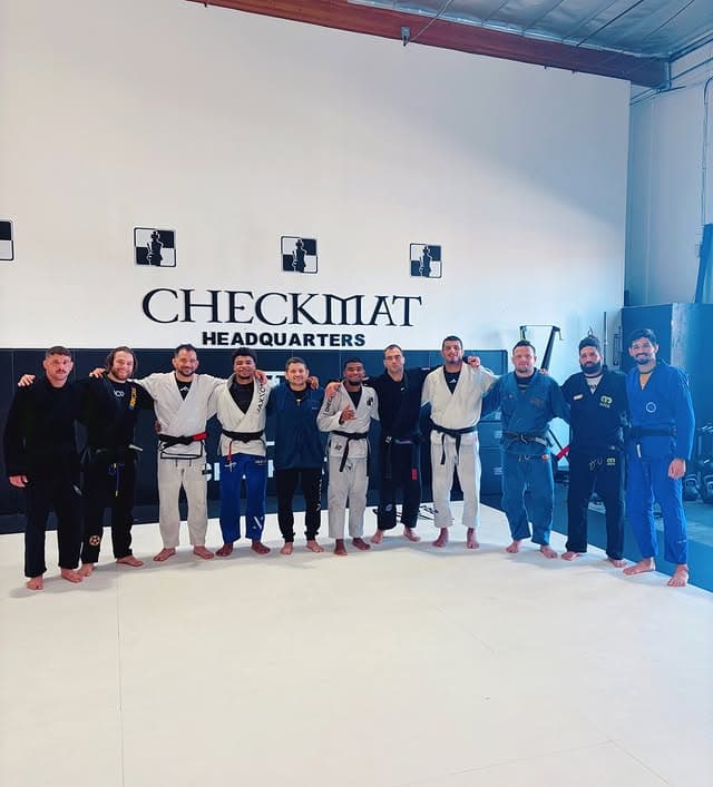 Checkmat Headquarters team photo with black belts in gis at Panza Jiu-Jitsu