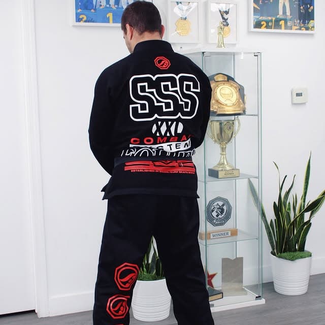 Luiz Panza looking at trophy case with medals and trophies at Panza Jiu-Jitsu Torrance